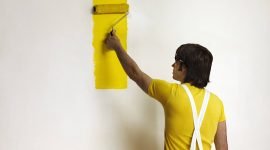 Young Man Painting Wall